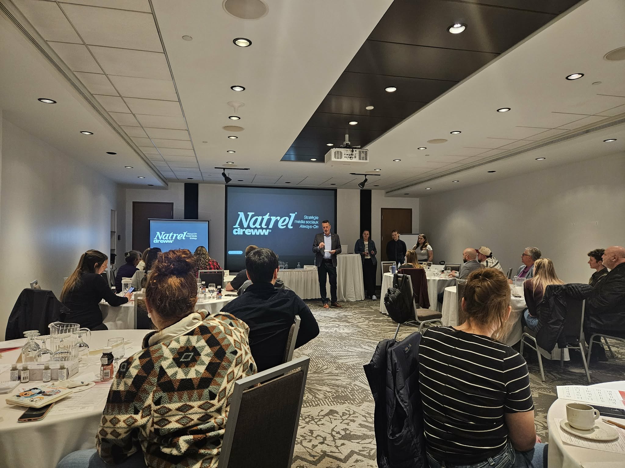 people gathered in a room for a presentation