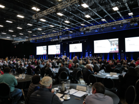 Large conference room with attendees and a stage