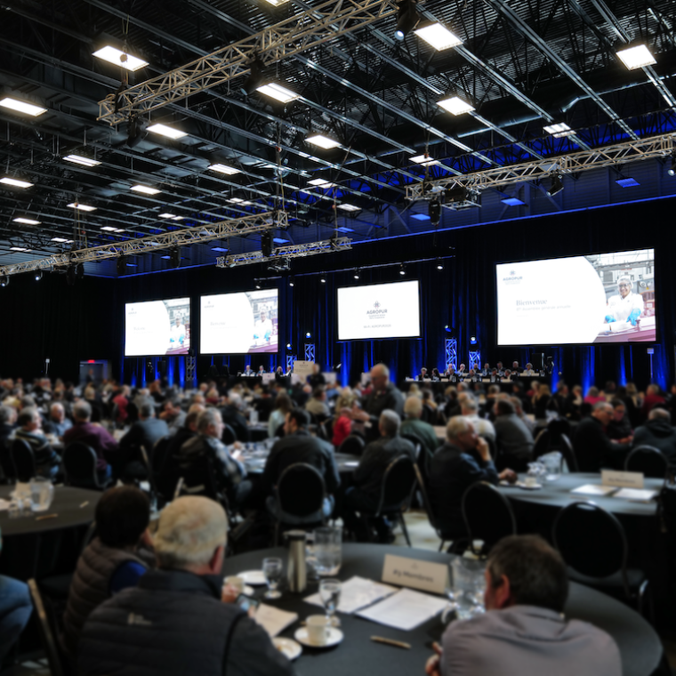 Large conference room with attendees and a stage