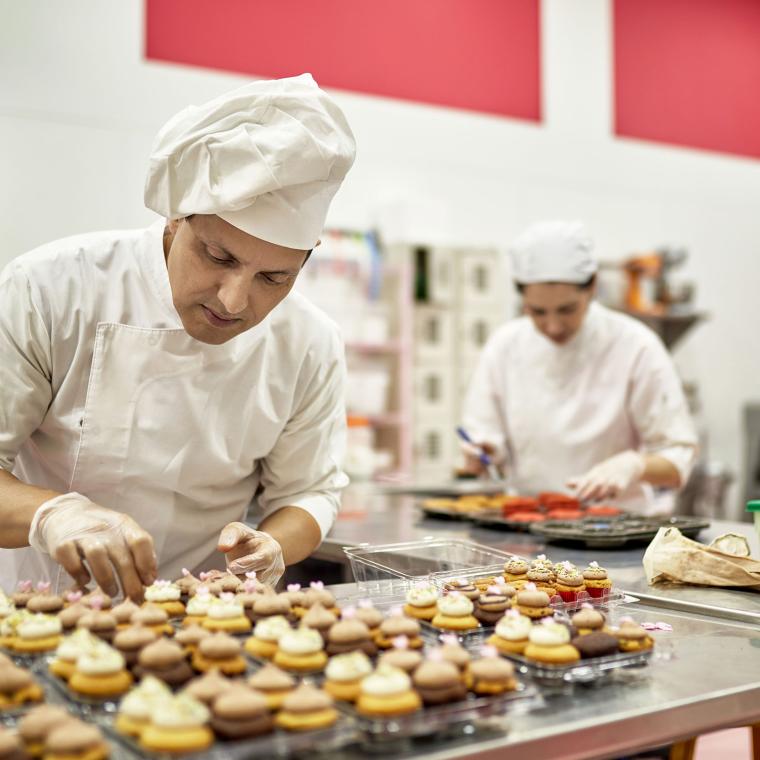 Hispanic American Chef Decorating Vegan Cupcakes in Kitchen