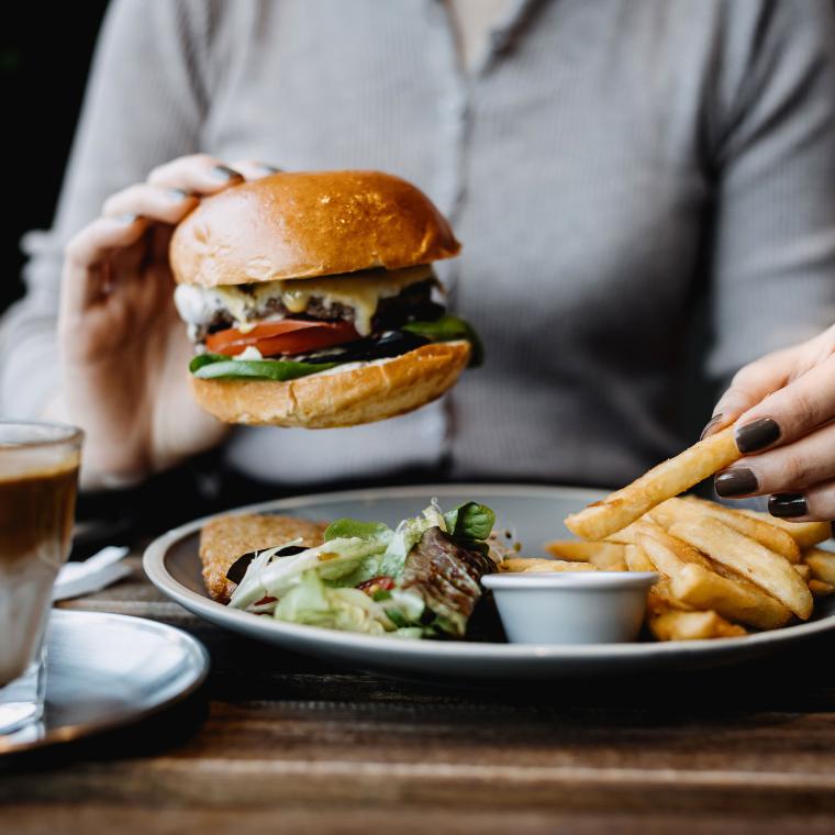 Getty 1356558824 - eating freshly made delicious cheeseburger