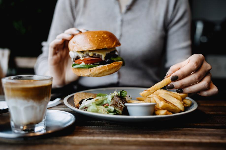 Getty 1356558824 - eating freshly made delicious cheeseburger